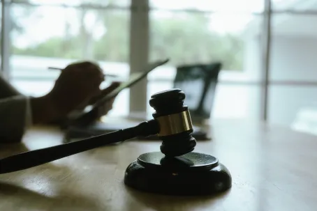 Professional lawyer consults client in office, reviewing legal documents and financial agreements to provide expert advice on law and justice.