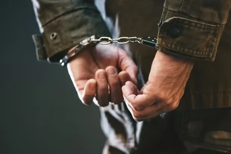 an image of a man arrested with handcuffed